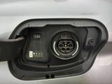 a close up of a car ' s fuel tank with a car plugged in