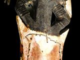 a close up of a wooden sculpture of a person on a horse