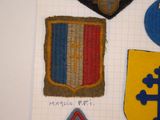 several patches of different colors and designs on a piece of paper