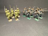 some toy soldiers are lined up and ready to be painted