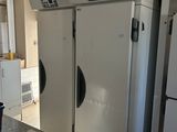 three white refrigerators in a kitchen next to each other