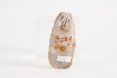 a rock with writing on it sitting on a white surface