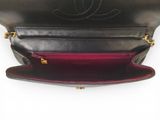 the inside of a black purse with a red lining