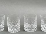 six glasses are lined up in a row on a table