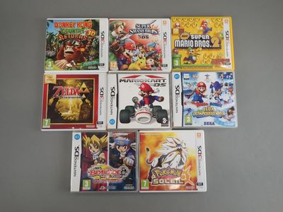several nintendo wii games sitting on top of a table next to each other