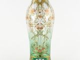 a glass vase with a gold and green design on it