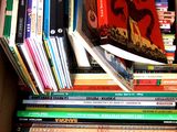 a box full of books that are stacked on top of each other
