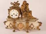 a gold clock sitting on top of a marble table