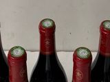 bottles of wine are lined up in a row on a counter
