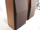 pair of speakers sitting on top of each other in a room