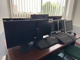 a desk with three computer monitors and a keyboard on it