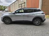a silver suv parked on the side of the road in front of a building