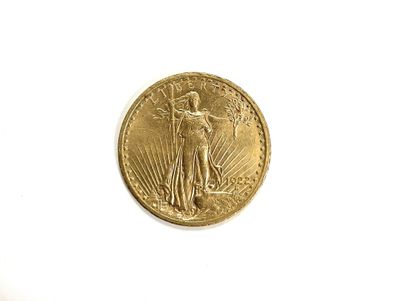 a close up of a gold coin on a white surface