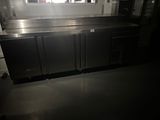 a kitchen with a stainless steel counter top and a refrigerator