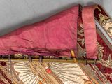 a pink umbrella with a gold design on the top of it