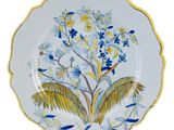 a blue and yellow plate with a bird and flowers on it