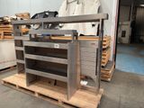 a metal rack with several shelves on it in a warehouse