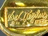 a close up of a gold plate with a sign on it