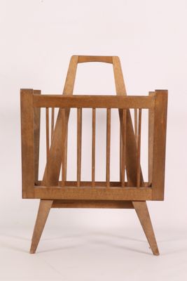 a wooden magazine rack with a magazine holder on it