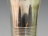 a silver cup that is sitting on a glass table