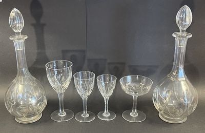 five wine glasses and a decanter on the table