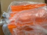 a box of carrots wrapped in plastic and sitting on a table