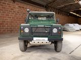 an image of a green land rover parked in a garage