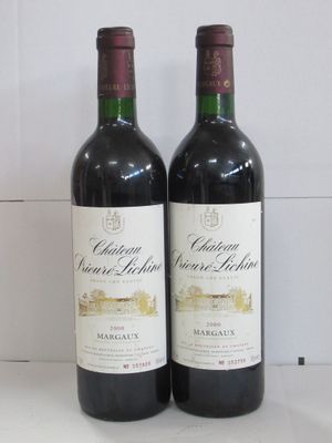 two bottles of wine sitting next to each other on a counter