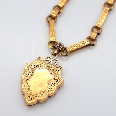 an image of a gold necklace with a pendant on a chain