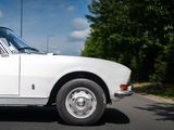 a white car that is parked on the side of the road