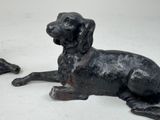 a statue of a dog that is laying down on the ground
