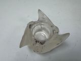 a small glass candle holder with a broken piece of glass on it