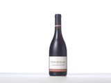 a bottle of red wine sitting on top of a table