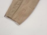 beige pants with a zipper on the side of them on a white surface