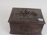 an old wooden box sitting on top of a white surface