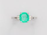 an oval emerald and diamond ring