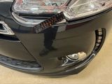 a close up of a car ' s headlight with a sticker on it