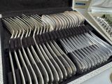 a lot of silverware in a case on a table