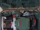 a green box with tools in it sitting on the ground