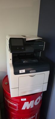 a red barrel with a printer on top of it
