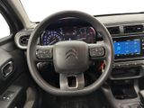 the interior of a car with a steering wheel and dashboard controls