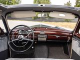 a view of the inside of a car from the driver ' s seat