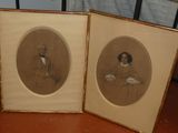 two framed pictures of a man and a woman on a table