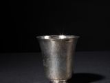 a silver cup that is sitting on a table