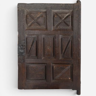 an old wooden door with many squares and squares on it