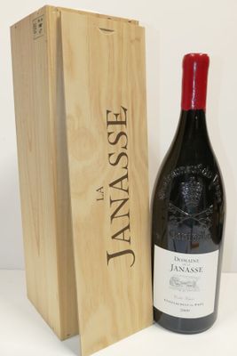 the bottle of wine is next to a wooden box on the table