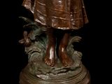 bronze statue of a woman holding a baby in her arms