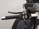 a close up of a motorcycle handlebar with a clock on it