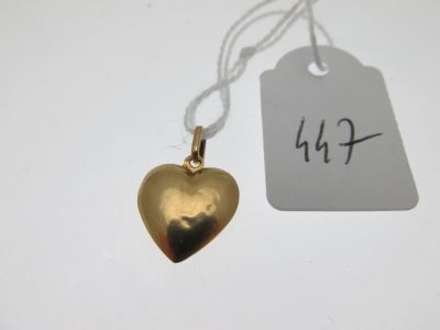 a gold heart pendant with a price tag attached to it