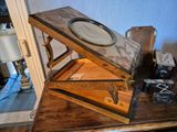 a wooden table with a mirror and a camera on it